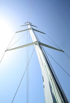 Mast of a sailboat against the blue sky