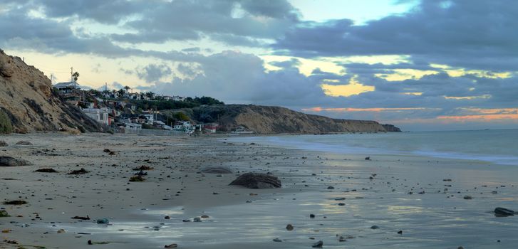 Cottages along Crystal Cove Beach, on the Newport Beach and Laguna Beach line in Southern California at sunset with a rainstorm looming.