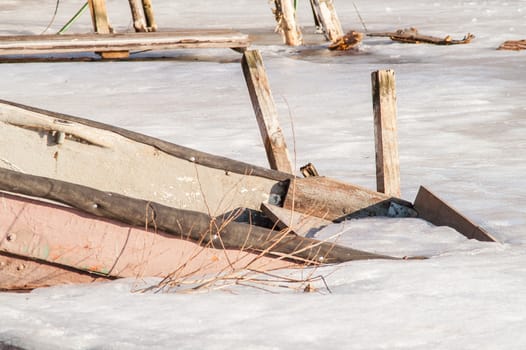 icebound old boat in the river during the day