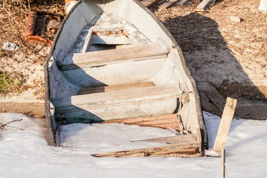 icebound old boat in the river during the day