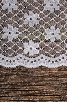 The openwork lace on a wooden background