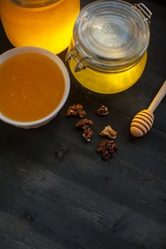 Honey with walnut on wooden background