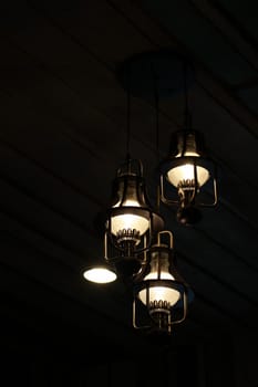 Light bulbs on black wood interiors background in Thai