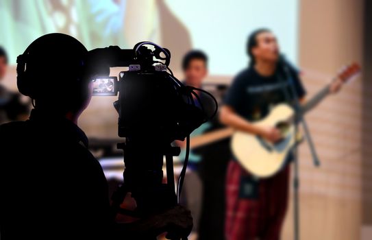 Cameraman shooting a live concert on stage