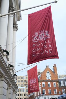 LONDON, UK - DECEMBER 20: Large red banners in front of the Royal Opera House, depicting the Royal coat of arms. December 20, 2015 in London.