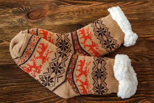 knitted socks with fur lining on a wooden surface