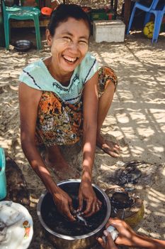 A woman is cleaning and preparing fresh caught squid for a meal.