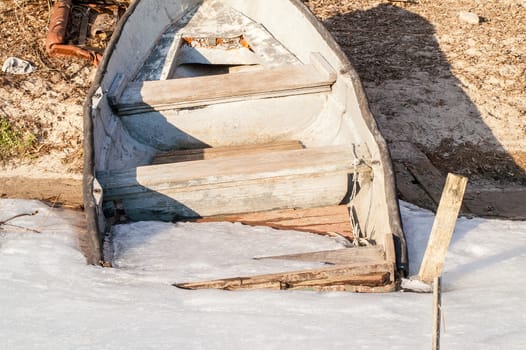 icebound old boat in the river during the day