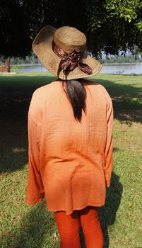 women  wear orange clothing at nature park in thailand