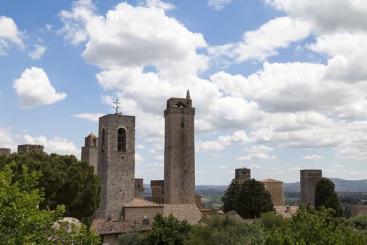view on some of famous towers in San Gimignano in Toscany in Italy on blue sky background