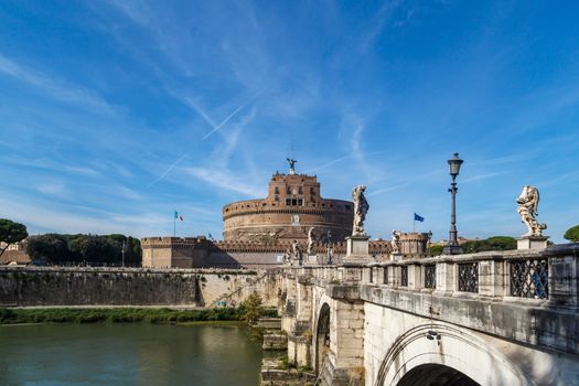 ROME, ITALY - SEPTEMBER 23, 2015 : Vıew of Castel Sant'Angelo, Castle of the Holy Angel built by Hadrian in Rome, along Tiber River on bright blue sky background.
