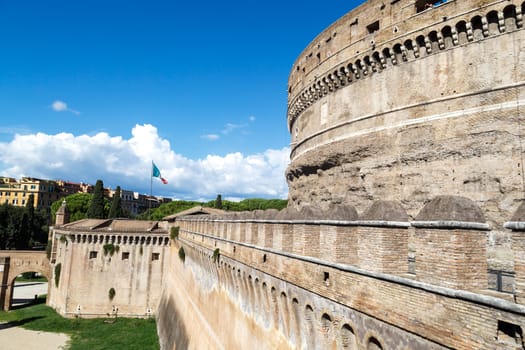 Close up detailed view of Castel Sant'Angelo, Castle of the Holy Angel built for Hadrian in Rome, on cloudy blue sky background.