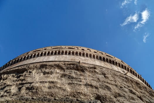 Close up detailed bottom view of Castel Sant'Angelo, Castle of the Holy Angel built for Hadrian in Rome, on bright blue sky background.