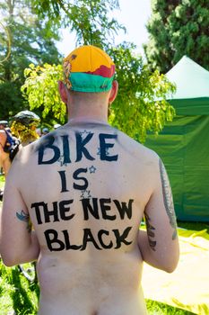 AUSTRALIA, Melbourne: A man with 'Bike is the new black' written on his back takes part in the World Naked Bike Ride (WNBR) on the streets of Melbourne on February 28, 2016.About 200 naked cyclists rode in the event called 'As bare as they dare'. The event aimed at raising awareness around cyclists' safety. 