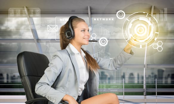 Smiling businesslady touching holographic screen, technology concept