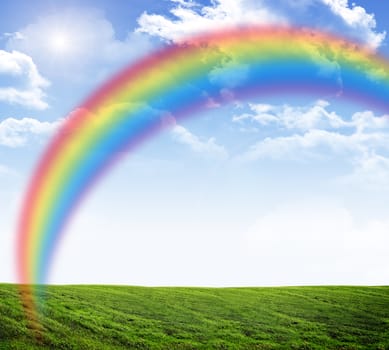 Blue sky with rainbow and green grass, nature concept