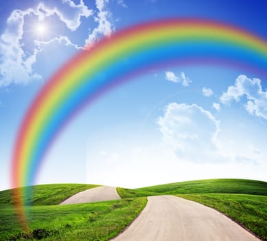 Blue sky with rainbow, road and green grass, nature concept