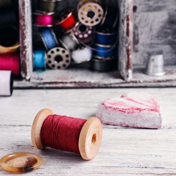 Beads,thread and bobbins for needlework.Picture in light key