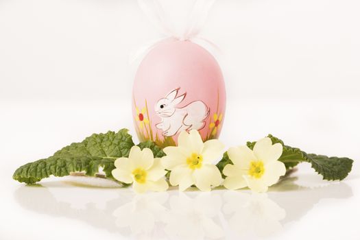 easter egg in spring flowers with background