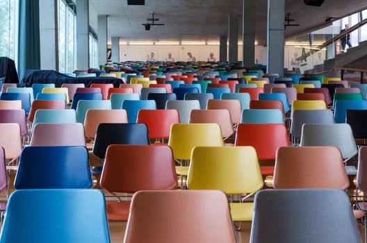Rows of colorful chairs in modern auditorium