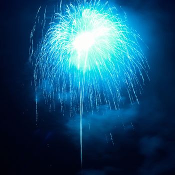 Blue fireworks on the black sky background