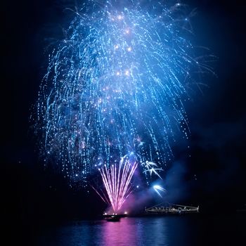 Blue fireworks on the black sky background