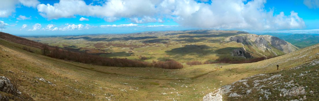 Panorama. Hills with cloudscape and blue sky.