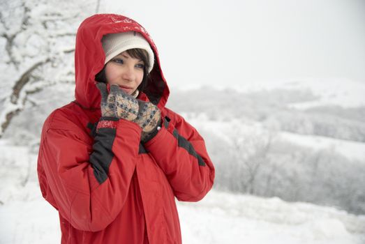 Pretty winter girl in the snow forest