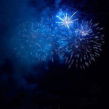 Blue fireworks on the black sky background