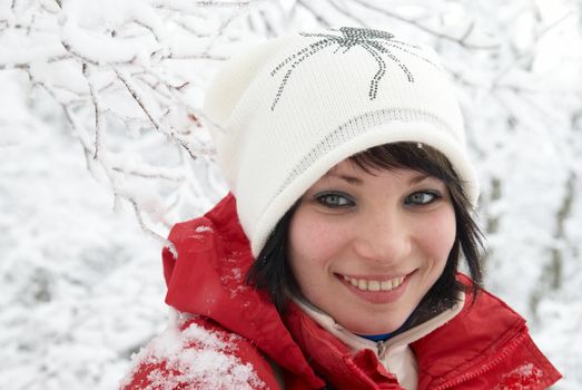 Pretty winter girl in the snow forest