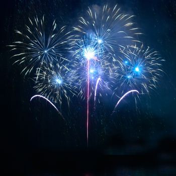 Blue fireworks on the black sky background