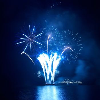 Blue fireworks on the black sky background