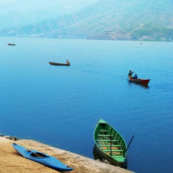 Wooden boats on the lake. Nepal evening.