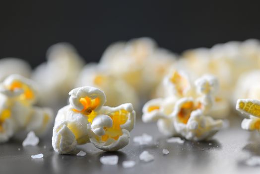 Popcorn and salt isolated on black background