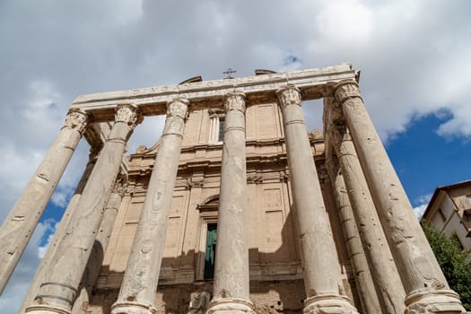 View of the ancient church at Roman Forum, on cloudy blue sky background.