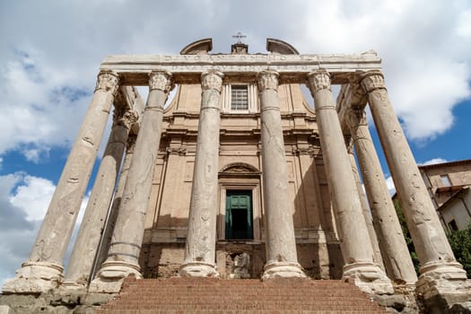 View of the ancient church at Roman Forum, on cloudy blue sky background.
