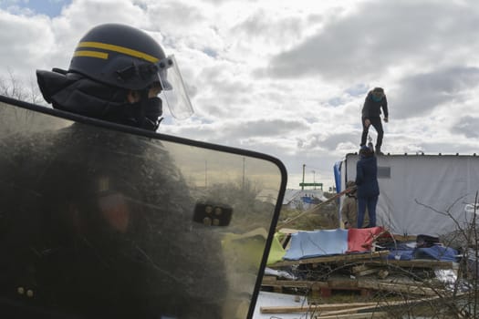 FRANCE, Calais: Policemen stand next to shelters on February 29, 2016 in the jungle migrants and refugees camp in Calais, northern France as agents dismantle the southern half of the sprawling camp in the port town.
A French court on February 25 gave the green light to plans to evacuate hundreds of migrants, with many wanting to stay near the entrance to the Channel Tunnel, the gateway to their ultimate goal of Britain. 
