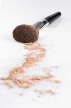 Close up view of face powder and brush on white back