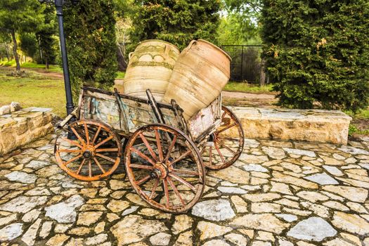 Old horse drawn wooden cart with jars 