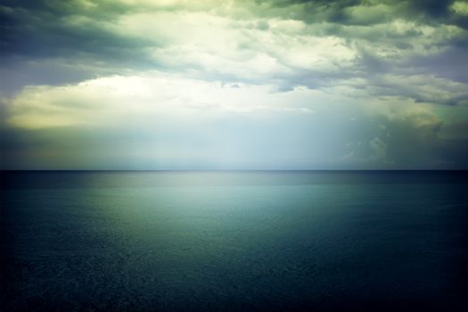 Light in the sky above the gloomy dark blue sea. Mediterranean nature.