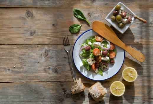 Greek cheese stuffed filo pastry with herbs in a dish on a wooden background with space