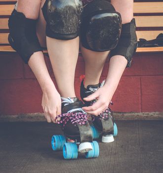 Woman on roller skates outside of a roller rink.