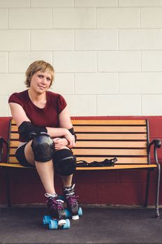 Woman on roller skates outside of a roller rink.