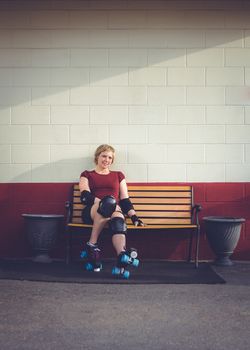 Woman on roller skates outside of a roller rink.