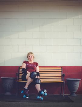 Woman on roller skates outside of a roller rink.