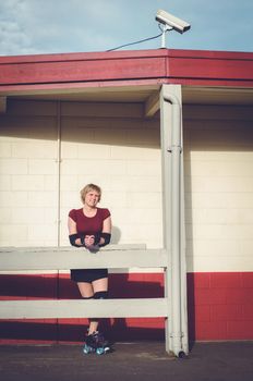 Woman on roller skates outside of a roller rink.