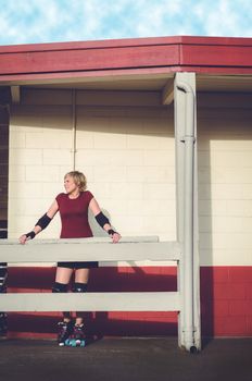 Woman on roller skates outside of a roller rink.