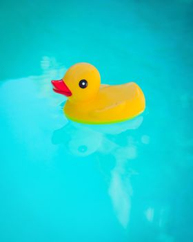 Rubber Ducky floating in deep blue water.