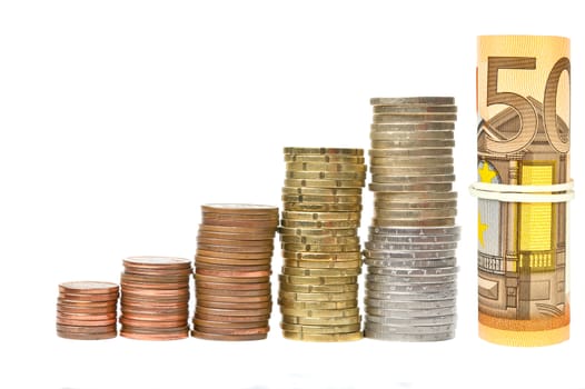 Coin columns and rolled banknotes isolated over white background