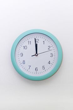 Round wall clock showing two minutes to midnight